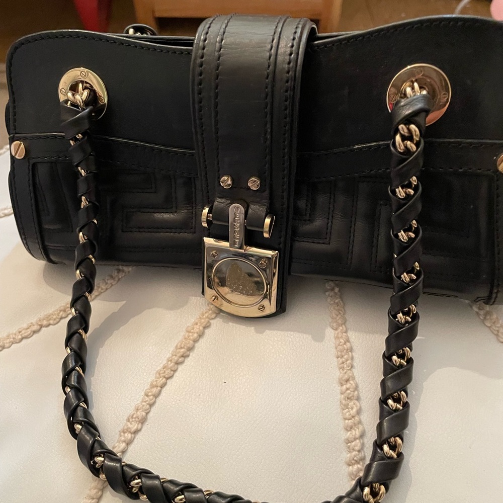 Versace mini purse with black and gold Versace symbol missing from front flap